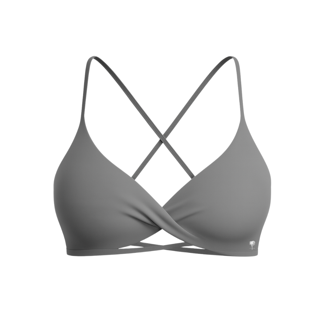 The Palm – CrossFlex™ Bra in gray. Sleek cross-front design with criss-cross straps and soft support for studio and everyday wear.