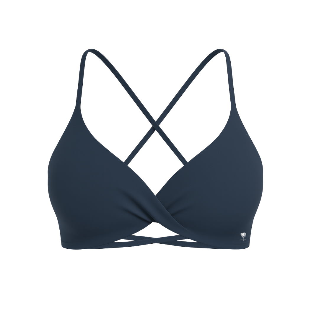The Palm – CrossFlex™ Bra in navy. Sleek scoop neckline with criss-cross straps and wrap front detail, crafted for flexible support and a flattering sculpted fit.