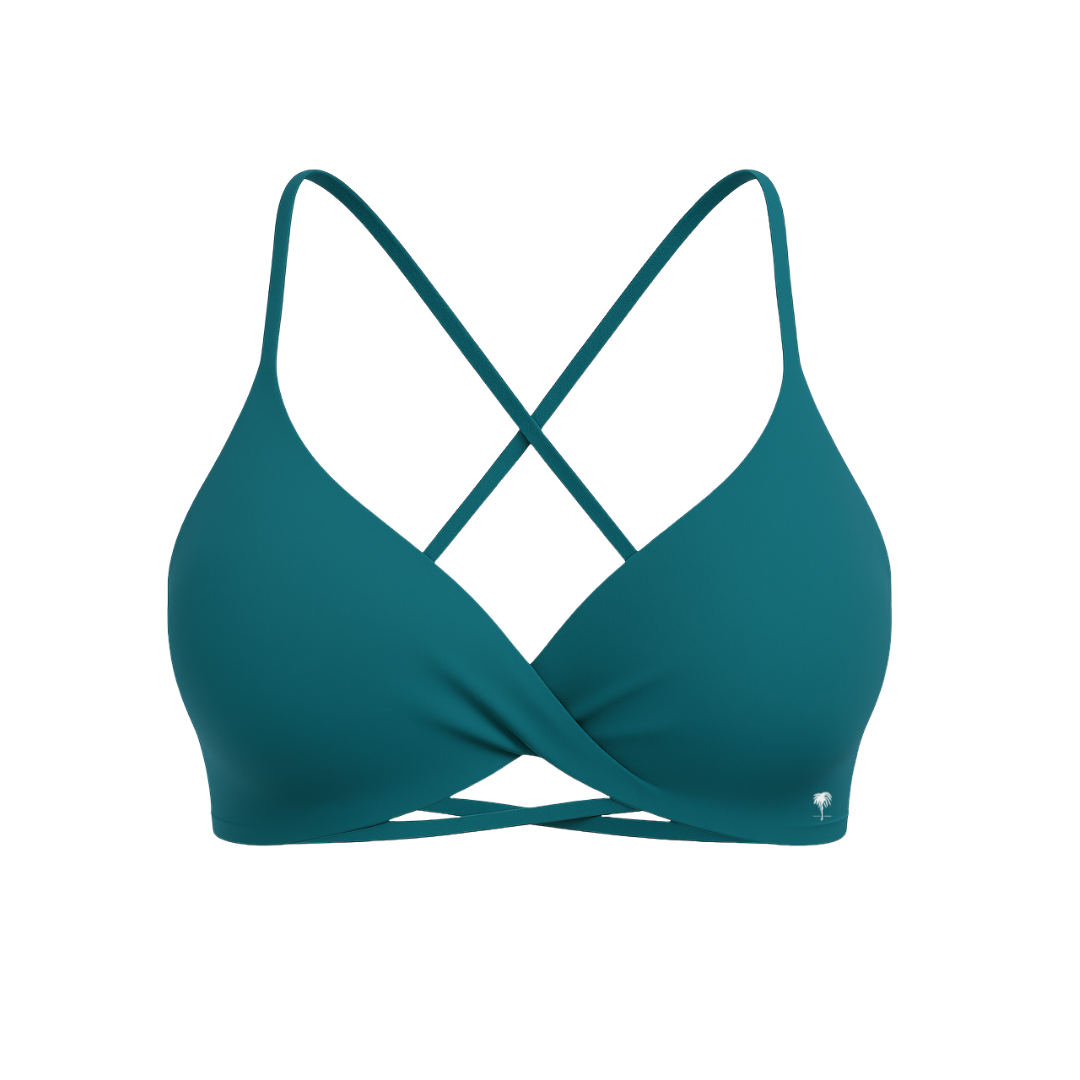 The Palm – CrossFlex™ Bra in teal. Sleek scoop neckline with criss-cross straps and wrap front detail, designed for flexible support and a flattering fit.