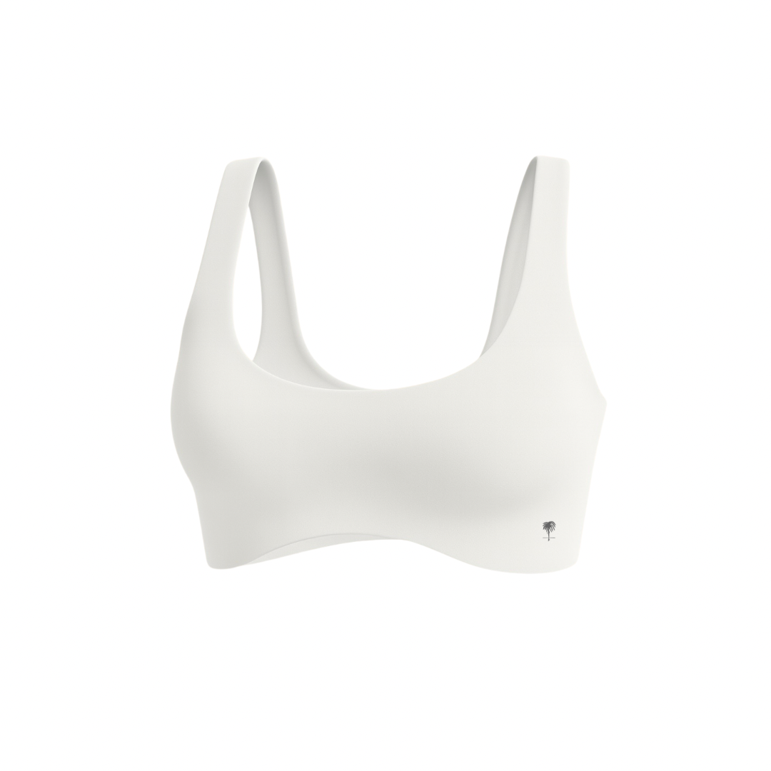The Palm — SoftSculpt Bra in white. Seamless, second-skin feel with flattering scoop neckline and wide straps for natural lift and support. Minimal, breathable, and designed to move with you.