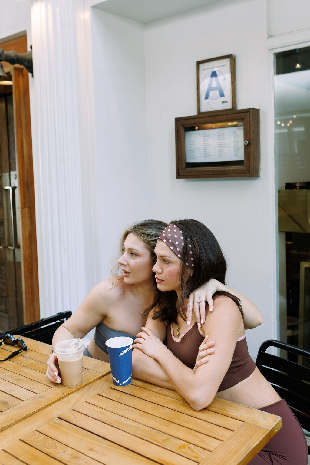 Two women in The Palm activewear sharing coffee and conversation in New York