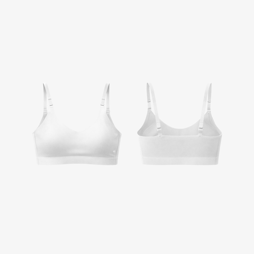 Front and back view of a white seamless AirFit™ bra with adjustable straps, displayed on a clean white background.