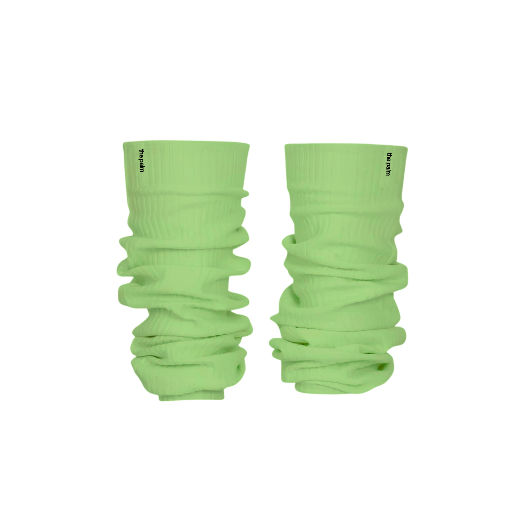 Ivory ribbed knit leg warmers by The Palm, featuring a minimalist logo tag and soft slouchy texture on a mint green background1