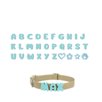 A grid displaying the complete alphabet and special symbols (heart, flower, star, paw) all in mint, with a separate dog collar showing an example of how the mint letters are attached to create a personalized name.