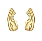 Minimalist gold sculptural cuffs with a fluid, organic shape on a white background 2