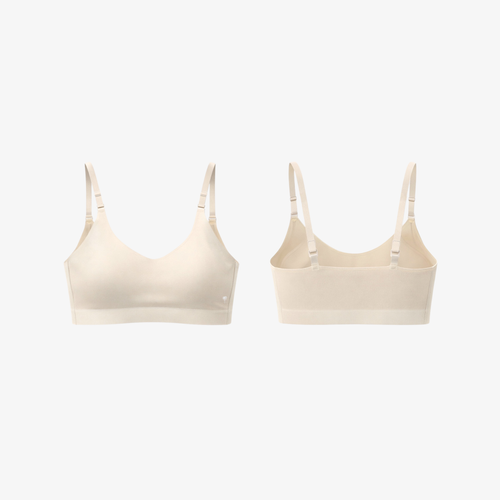 Soft light beige AirFit™ seamless everyday bra top featuring thin adjustable spaghetti straps.