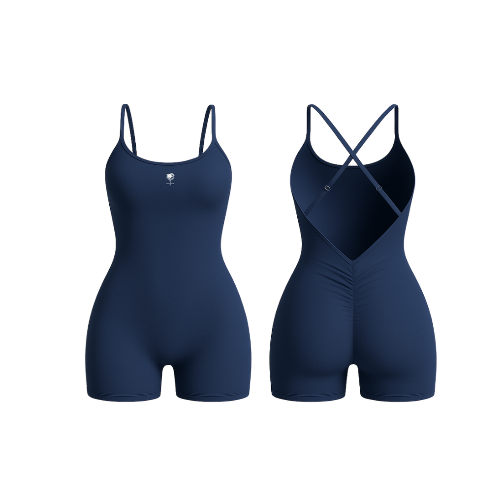 The Palm – BareForm™ Studio Romper in Navy. Seamless sculpting one-piece with cross-back straps and flattering ruching. Designed for performance, style, and movement with a second-skin fit and smooth finish. Confidence meets comfort.