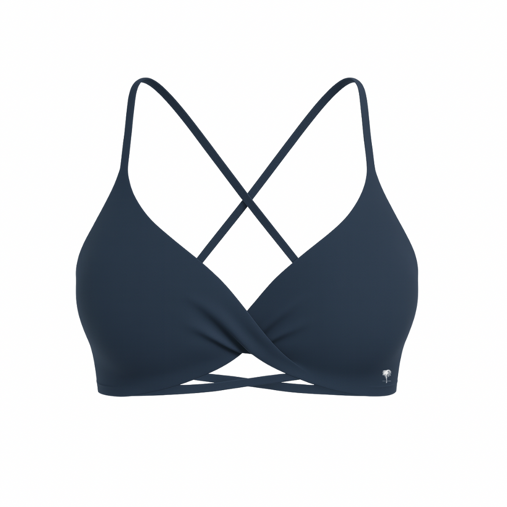 The Palm – CrossFlex™ Bra in navy. Sleek scoop neckline with criss-cross straps and wrap front detail, crafted for flexible support and a flattering sculpted fit.