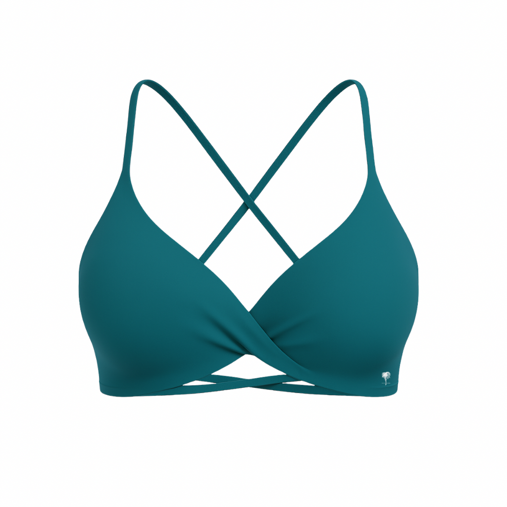 The Palm – CrossFlex™ Bra in teal. Sleek scoop neckline with criss-cross straps and wrap front detail, designed for flexible support and a flattering fit.