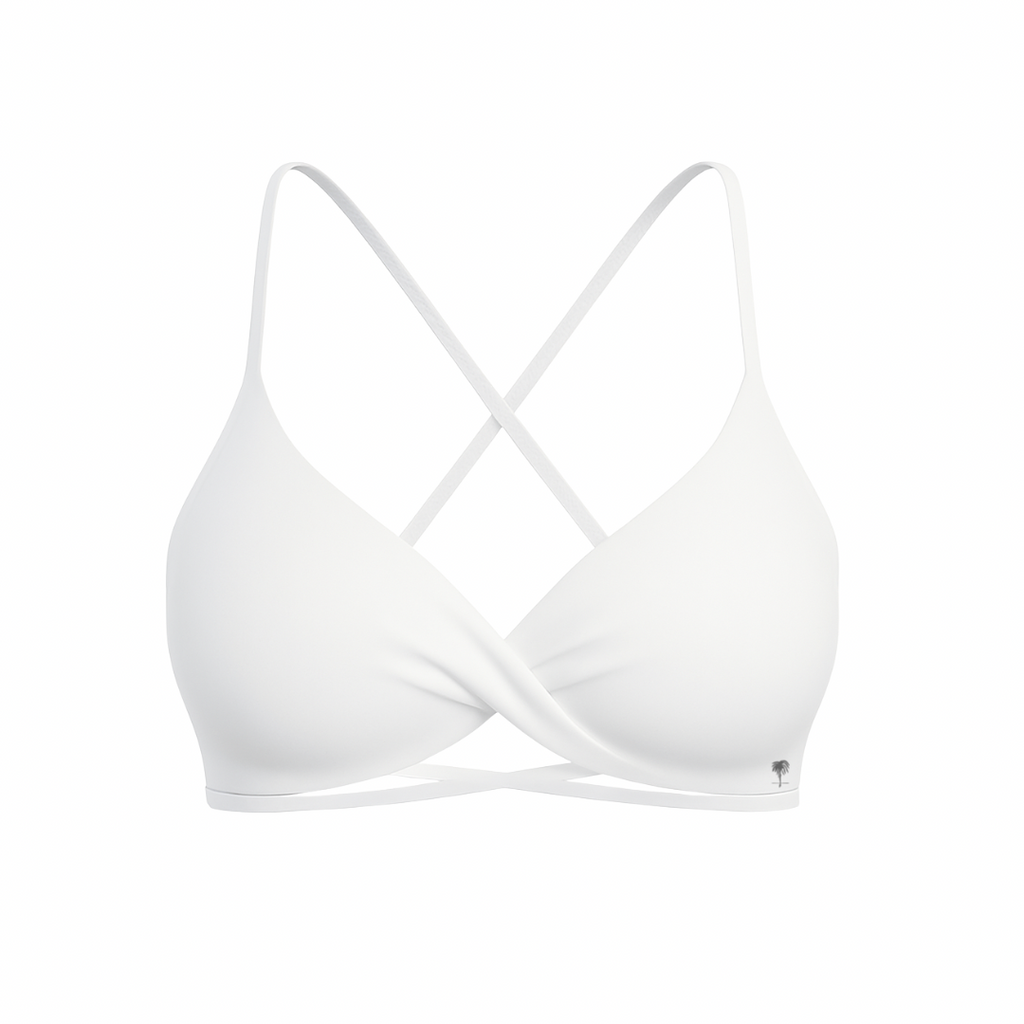 The Palm – CrossFlex™ Bra in white. Sleek scoop neckline with criss-cross straps and wrap front detail, designed for flexible support and a flattering fit.