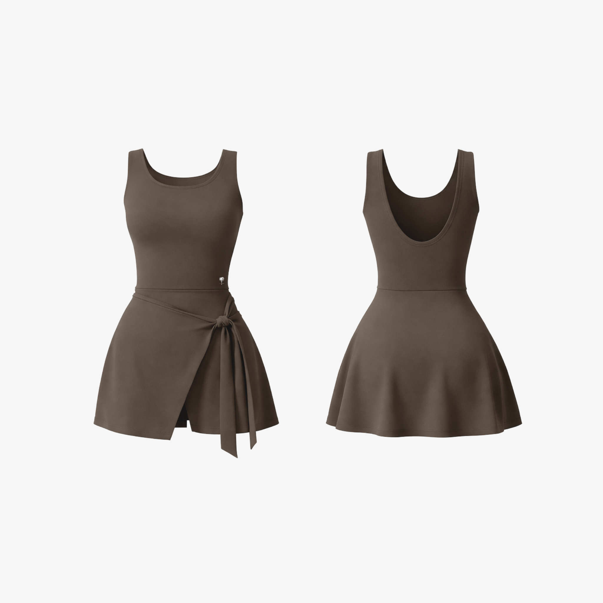 The Palm DrapeFit™ Wrap Romper in Espresso. A sculpting activewear romper featuring a feminine wrap-skirt detail, built-in shorts, and a flattering silhouette designed for movement and everyday confidence.