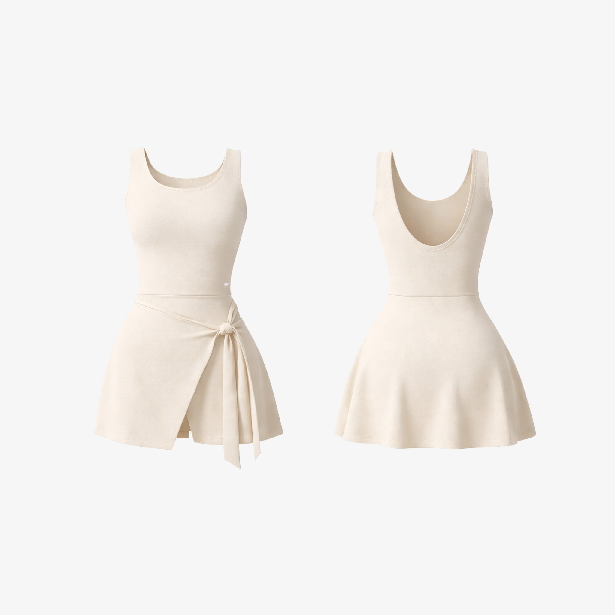 The Palm DrapeFit™ Wrap Romper in Ivory. A flattering activewear romper featuring a wrap-skirt silhouette, built-in shorts, and a luxurious stretch fabric for effortless movement and timeless style.