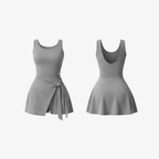 The Palm DrapeFit™ Wrap Romper in Mist Grey. A sculpting activewear romper with a feminine wrap-skirt detail, built-in shorts, and a soft second-skin feel designed for movement and everyday elegance.