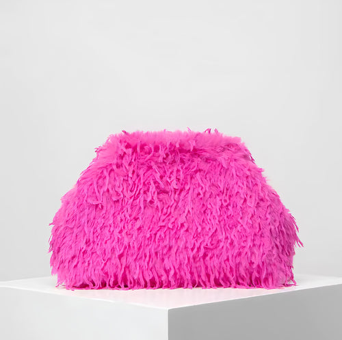 The Palm FeatherLuxe™ bag in Hot Pink. Plush feather-textured clutch with a sculptural shape, merging playful color with elevated minimal design.