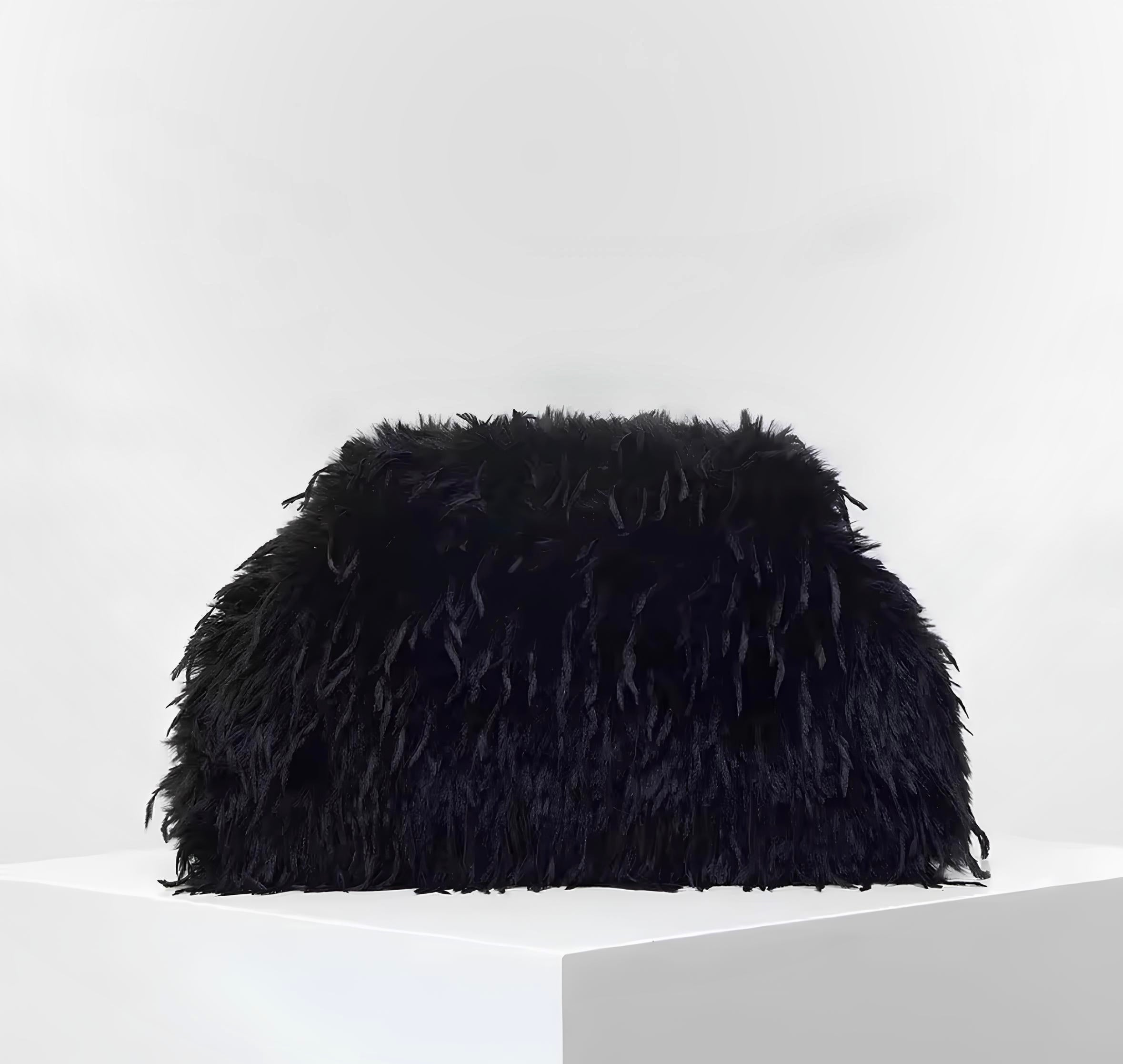 The Palm FeatherLuxe™ bag in Jet Black. Plush textured clutch with soft feathered finish and sculptural silhouette designed for elevated evening wear.
