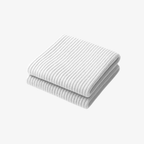 The Palm FlexWarm™ Legwarmers in White. Soft ribbed knit leg warmers styled with heels, designed for studio layering and effortless elegance.