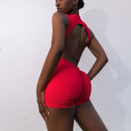 Close-up back view of sculpting red romper by The Palm — open back and lifted fit design
