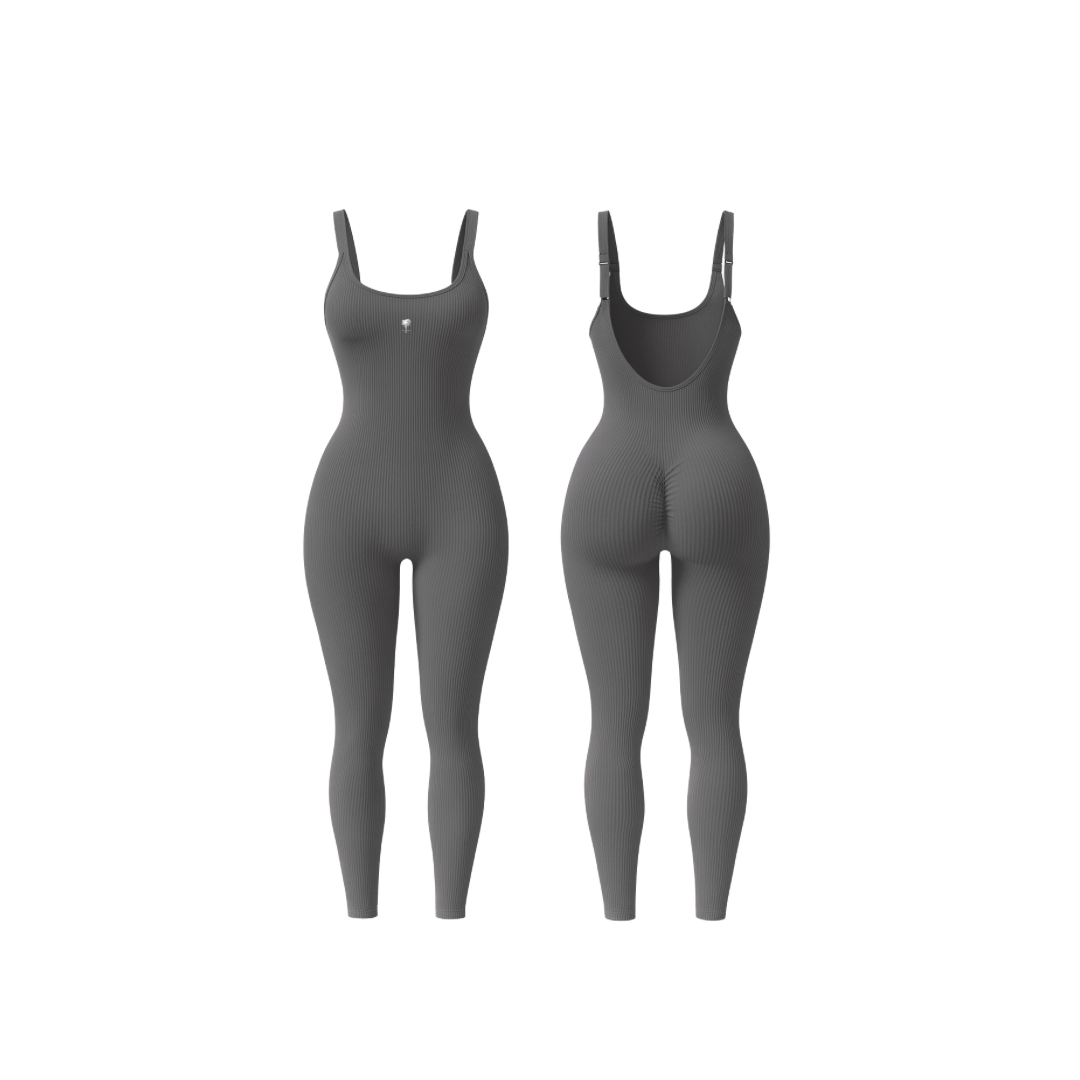 The Palm – ShapeFlex™ Suit in dark grey. Seamless full-length ribbed bodysuit with sculpting compression, four-way stretch, and second-skin fit. Designed to accentuate curves while allowing total freedom of movement, this versatile piece transitions effortlessly from studio to street with moisture-wicking fabric and a sleek, contour-hugging silhouette.