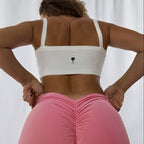 The Palm SoftRib™ Top in white, back view showcasing a smooth ribbed texture and clean minimalist fit.