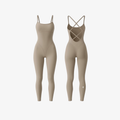 StrapSculpt™ Jumpsuit by The Palm in Soft Beige. A sculpting, breathable nylon-spandex one-piece with delicate spaghetti straps and an open cross-back design, crafted for a smooth, elongated silhouette.