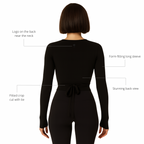 Black long-sleeve jumpsuit with design features highlighted on a white background